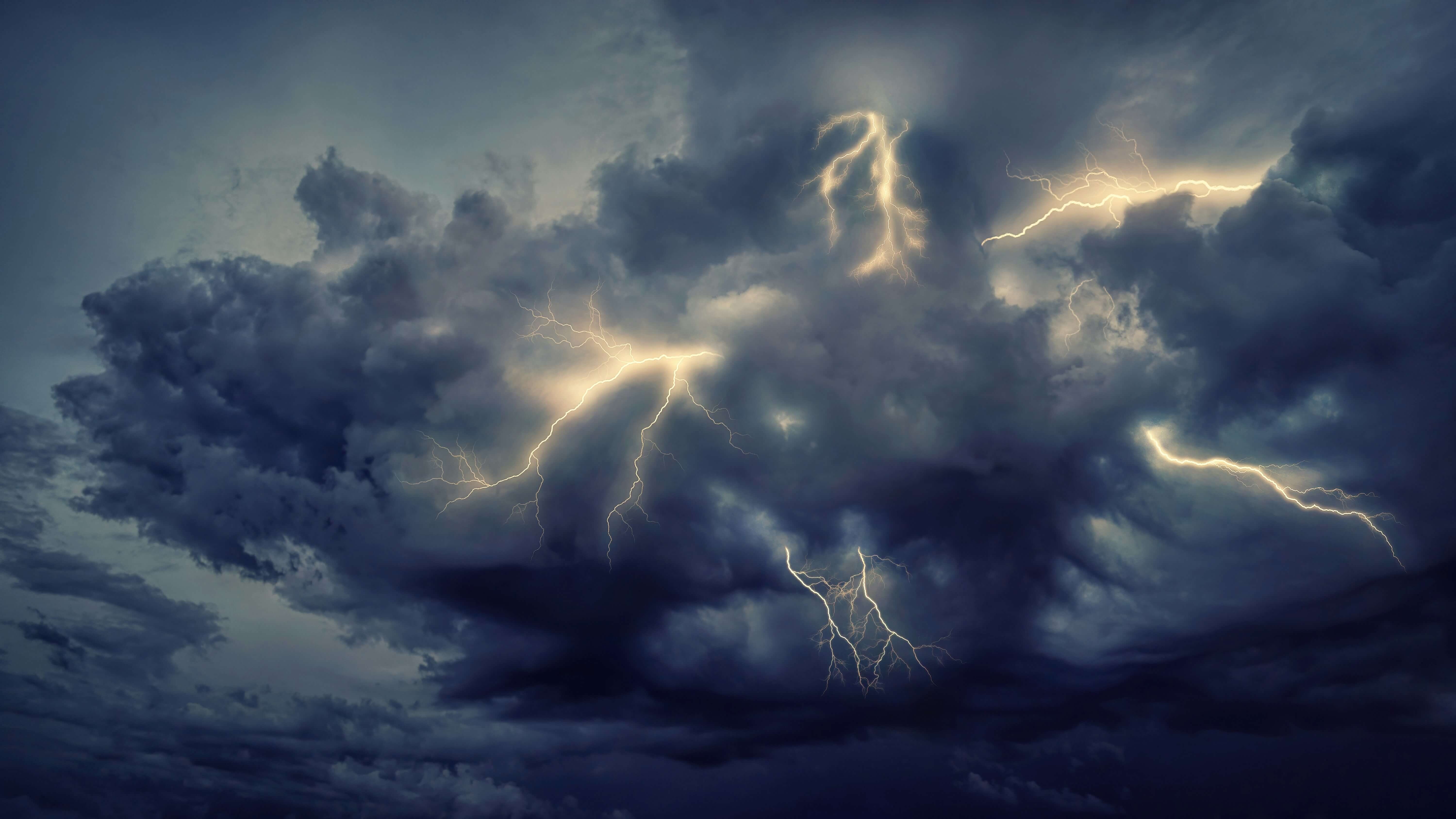 a lightning storm looming over a countryside