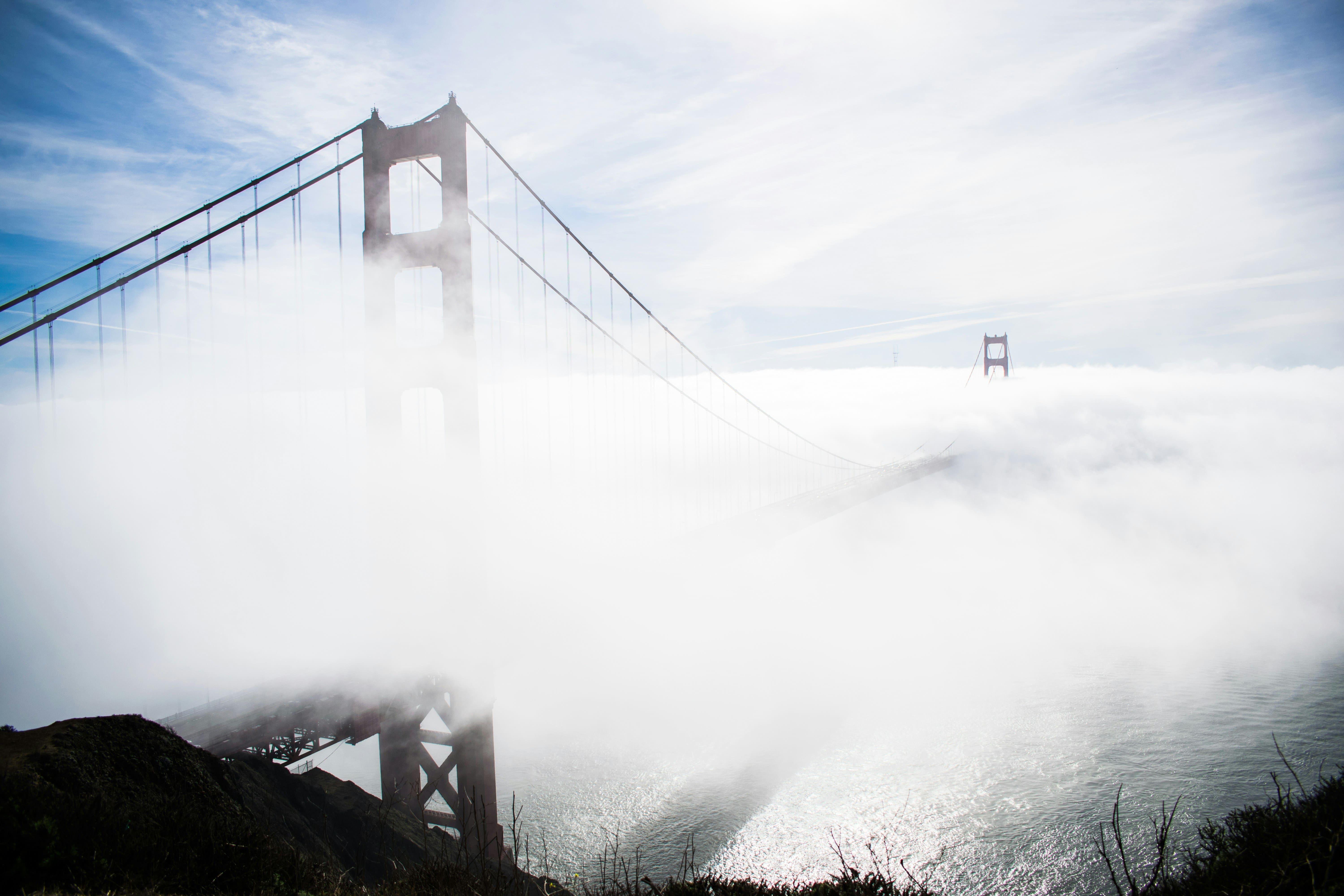 a low cloud of fog covering the golden gate bridge