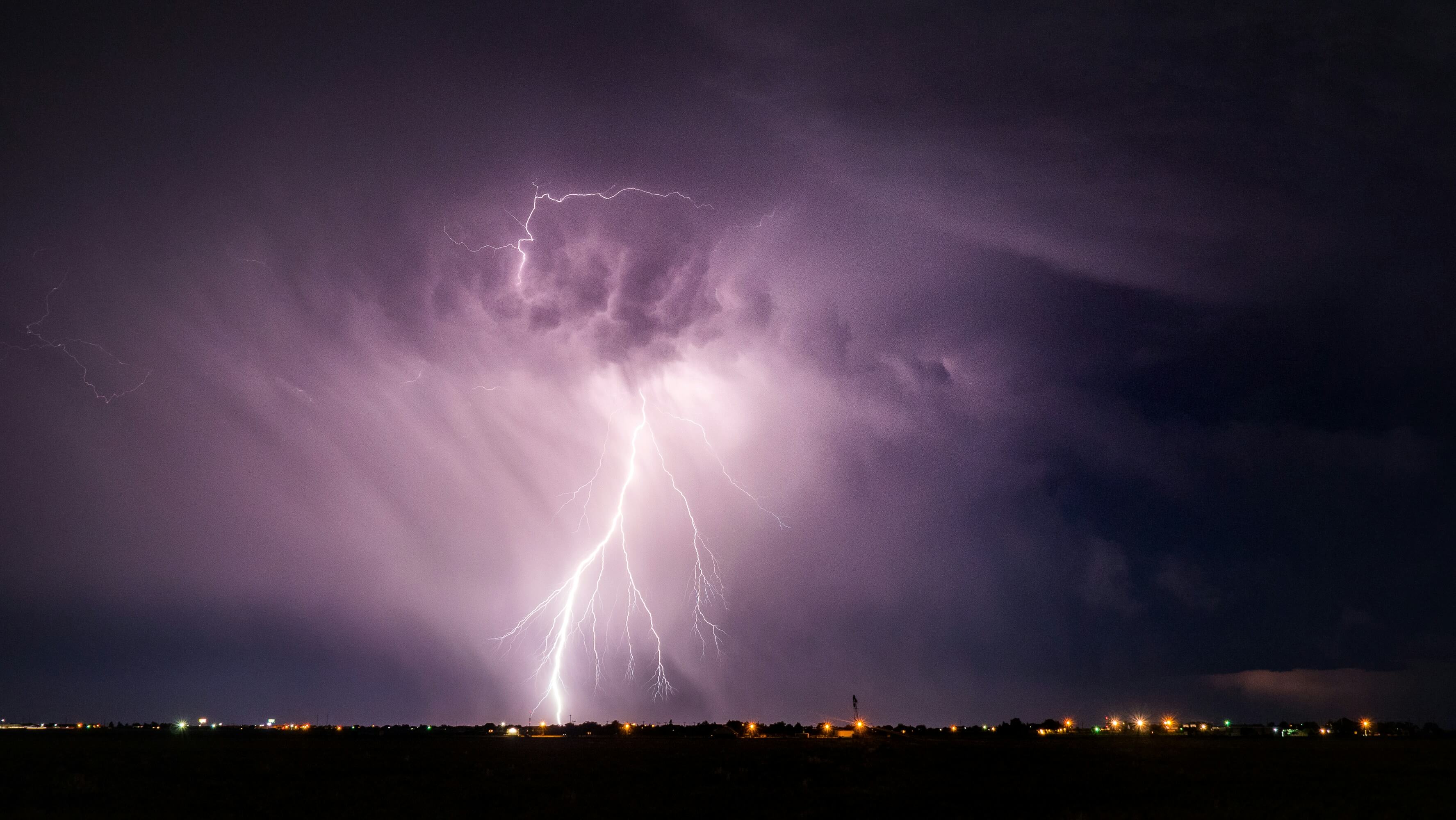 a lightning bolt striking the ground around a town