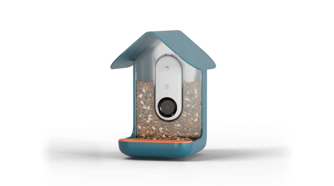 the bird buddy smart bird feeder in blue with a built-in camera and filled with bird seeds