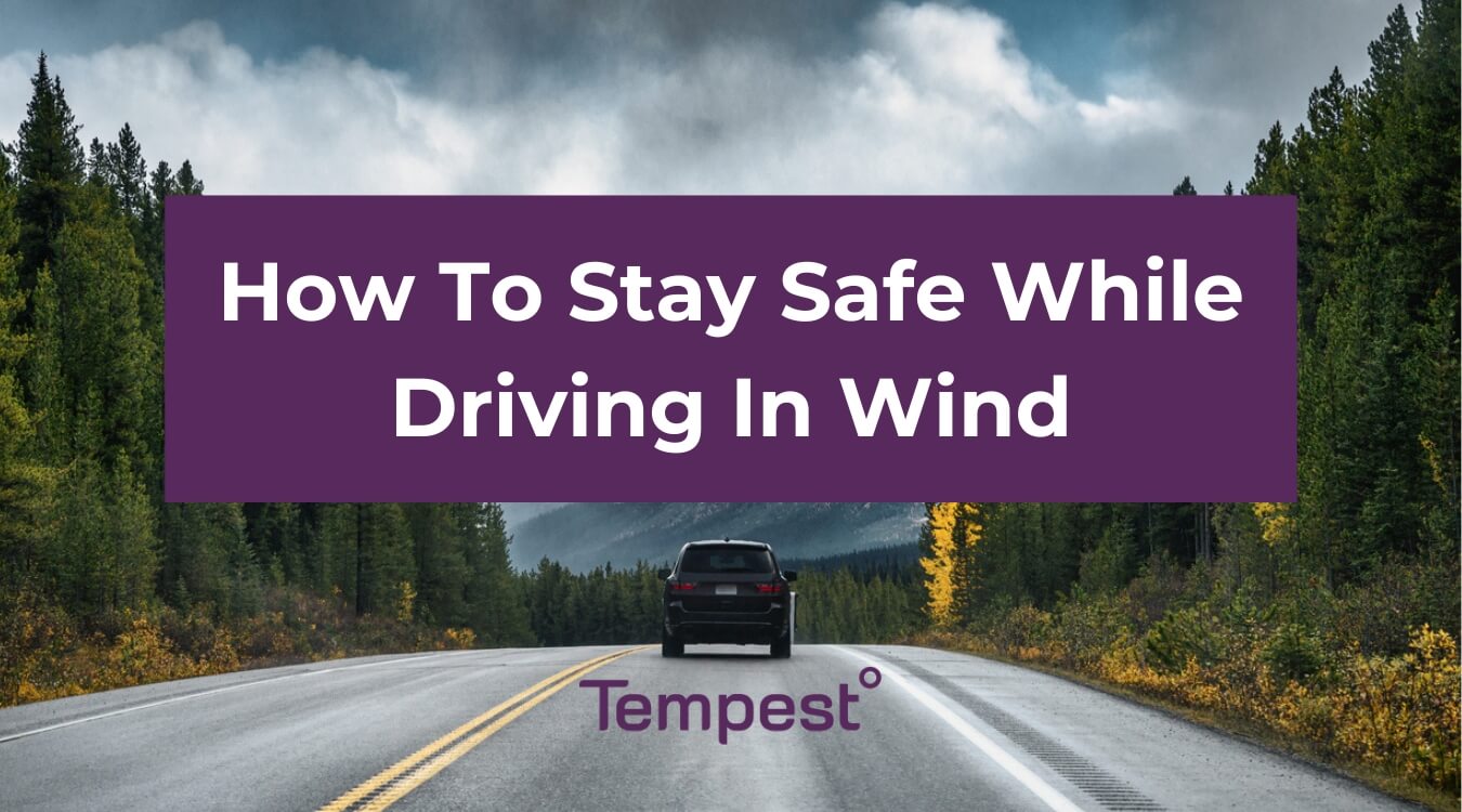 a car safely driving on a highway on a windy day